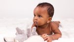 11331382 - adorable little african american baby girl  lying down